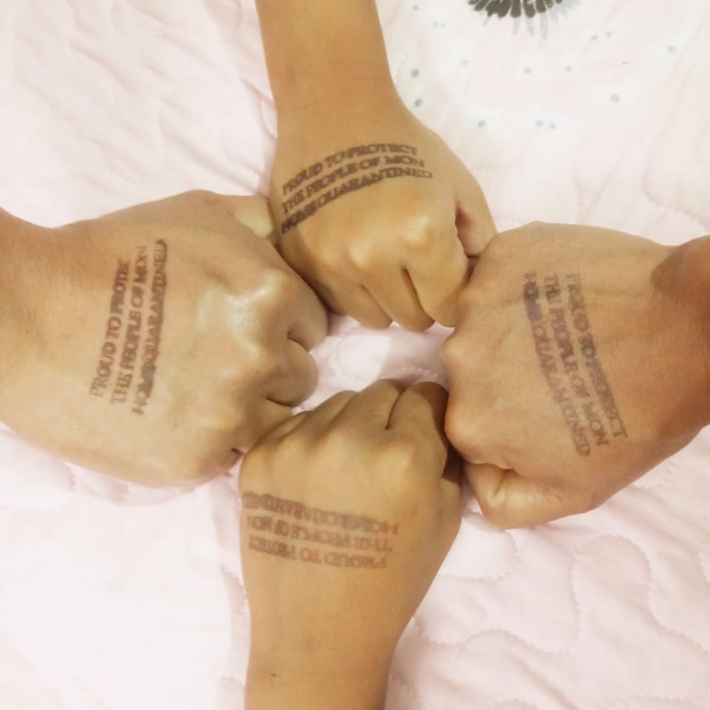 Hands stamped to indicate home quarantine